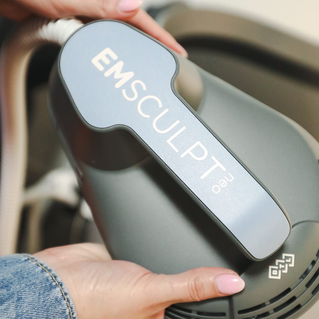 Hand holding EMSculpt device