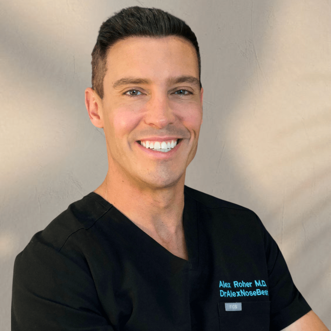 Dr. Alex Roher, MD, smiling in a black medical uniform, representing SDBotox's commitment to aesthetic treatments in San Diego.